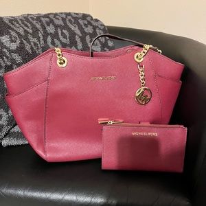Dark maroon Michael Kors bag with matching wallet. Gold chain straps .